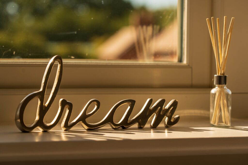 sign in windowsill that says dream