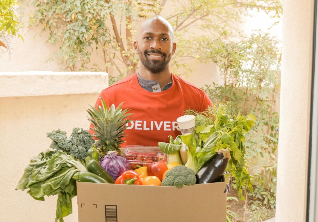 man delivering groceries, fruits and vegetables.