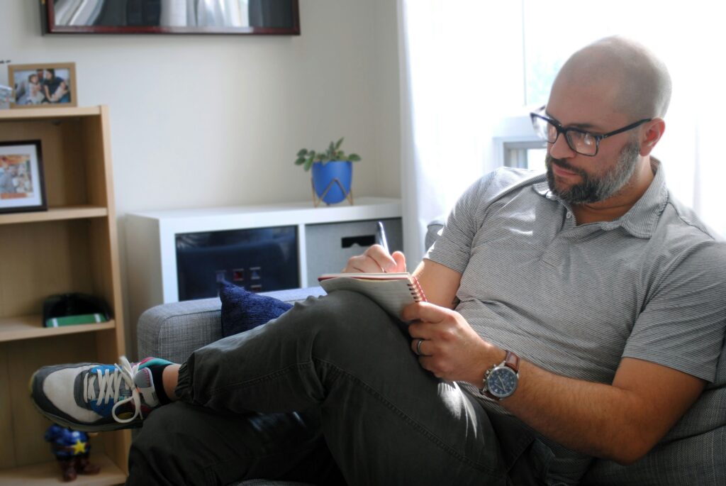 man sitting writing and planning
