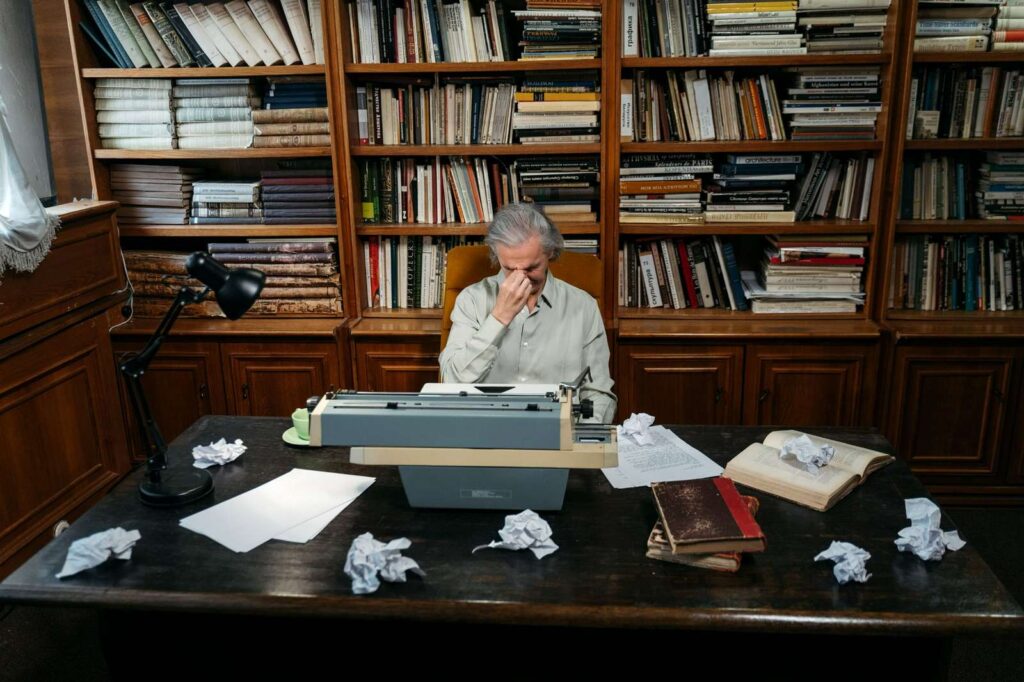 man sitting at a desk in home office library