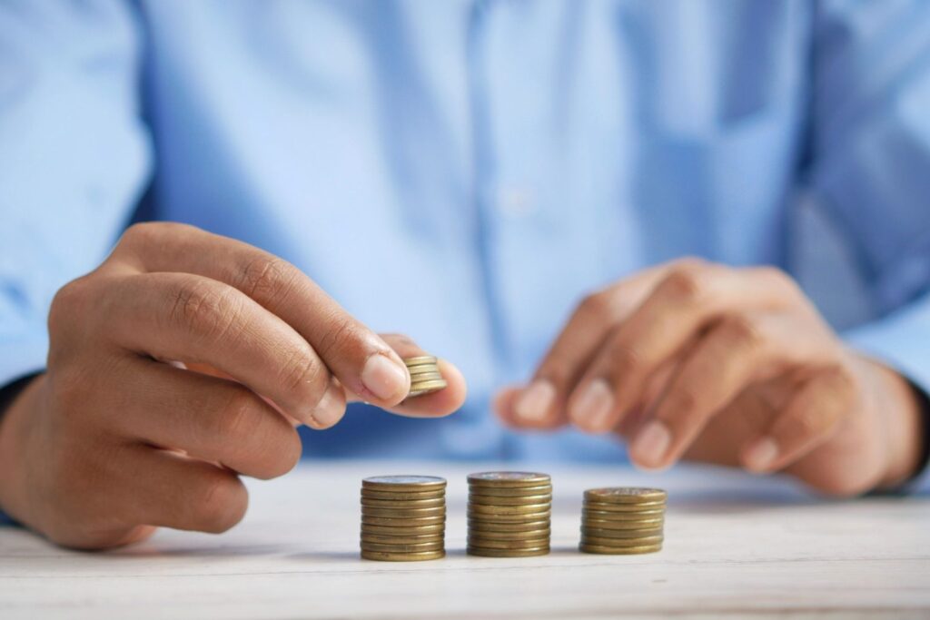 main counting and stacking up coins - live better after 50
